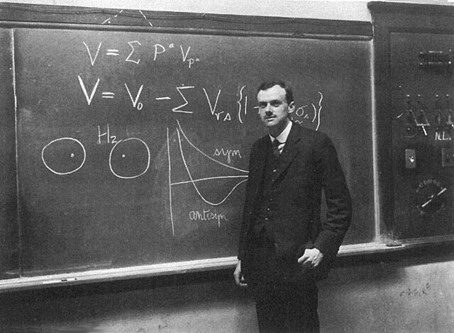 PAM Dirac infront of blackboard